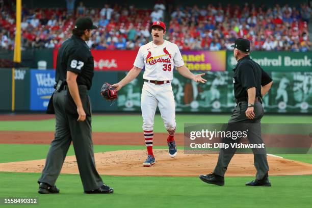 Miles Mikolas of the St. Louis Cardinals reacts after being ejected from the game for hitting a batter in the first inning against the Chicago Cubs...