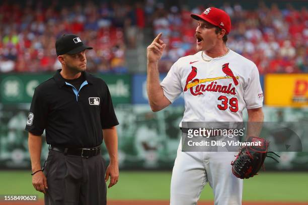Miles Mikolas of the St. Louis Cardinals shares his feelings with the Chicago Cubs dugout after being ejected for hitting a batter in the first...