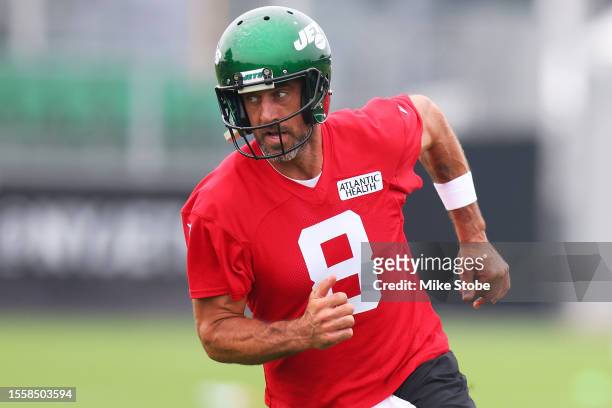Aaron Rodgers of the New York Jets run drills during training camp at Atlantic Health Jets Training Center on July 20, 2023 in Florham Park, New...