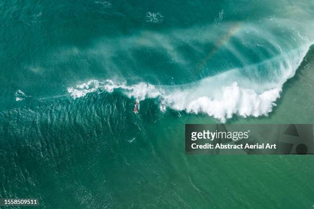 surfer on a large ocean wave shot from an aerial point of view - gold coast wave stock pictures, royalty-free photos & images