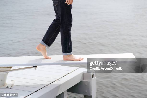 low section of young man on diving board - acb stock pictures, royalty-free photos & images