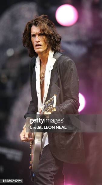 Guitarist Joe Perry of rock group Aerosmith performs on stage at Wembley stadium in north London, 01 July 2007, as 60 000 revellers join Princes...