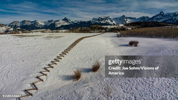 Aerial view of snake fence and snow leading to San Juan Mountains, Colorado.