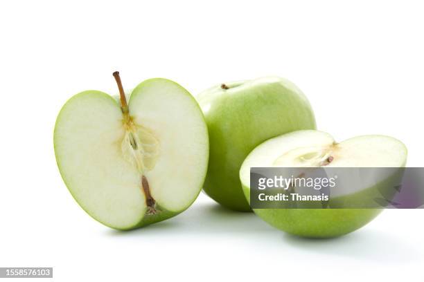 whole and sliced green apples on white background - half complete stock pictures, royalty-free photos & images