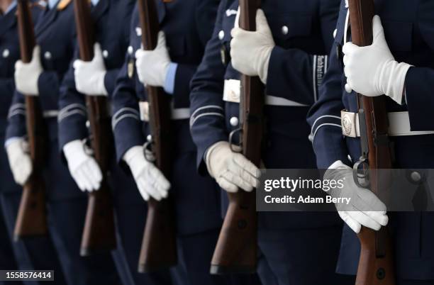 Soldiers attend a ceremony in which new recruits of the Bundeswehr, the German armed forces, take their oath of service, on July 20, 2023 in Berlin,...