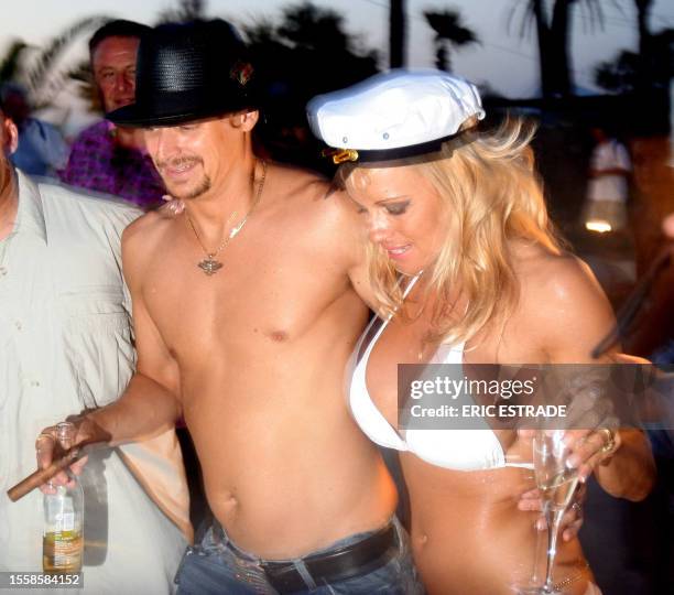 Canadian actress Pamela Anderson shares a drink with her husband, US musician Kid Rock, the day of their wedding, on Pampelone's beach in...