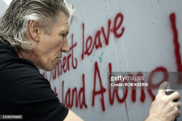 British rock legend Roger Waters, co-founder of the group Pink Floyd, spraypaints a graffiti against Israel's separation barrier surrounding the West...