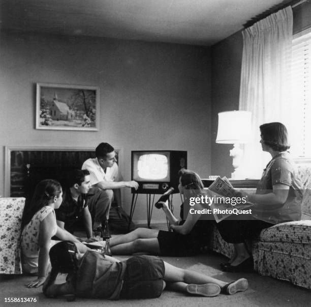 View of James S Thomas and his family as they watch television in their living room, Vienna, Virginia, 1958.