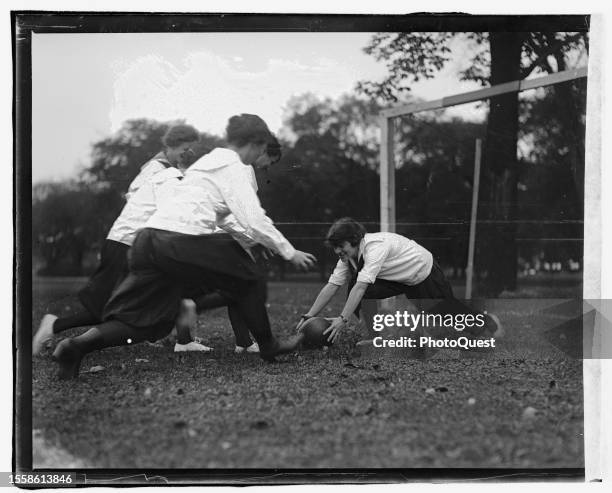 Five girls, dressed in bloomers and middy blouses, play soccer, Washington DC, circa 1919.