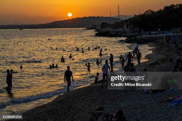 Athenians on Alimos city beac to cool them self after sunset during a heat wave on July 20, 2023 in Athens, Greece. The Acropolis of Athens and other...