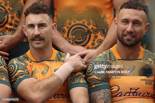 Australia's Nic White and Quade Cooper pose for a team photo during a training session at Brighton Grammar School in Melbourne on July 28 ahead of...
