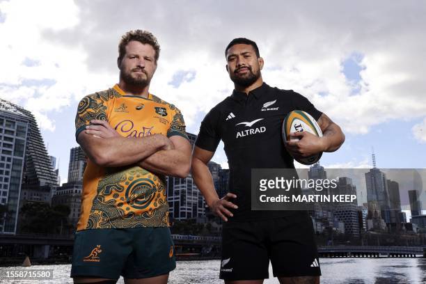 Australia's co-captain James Slipper and New Zealand's Captain Ardie Savea pose for a photo during a press conference in Melbourne on July 28 ahead...