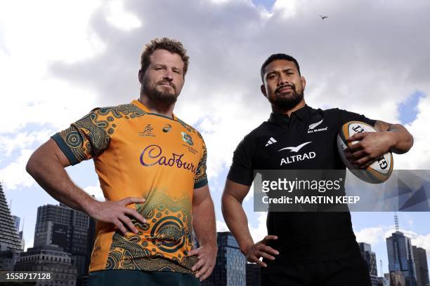 Australia's co-captain James Slipper and New Zealand's Captain Ardie Savea pose for a photo during a press conference in Melbourne on July 28 ahead...