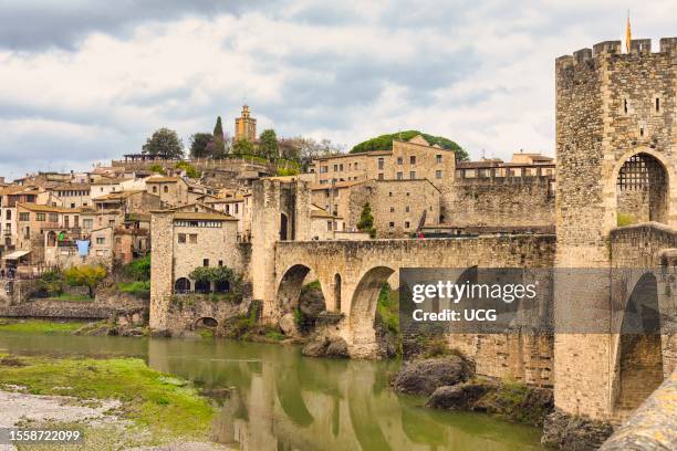 Besalu, Girona Province, Catalonia, Spain. Fortified bridge known as El Pont Vell, the Old Bridge, crossing the Fluvia river.