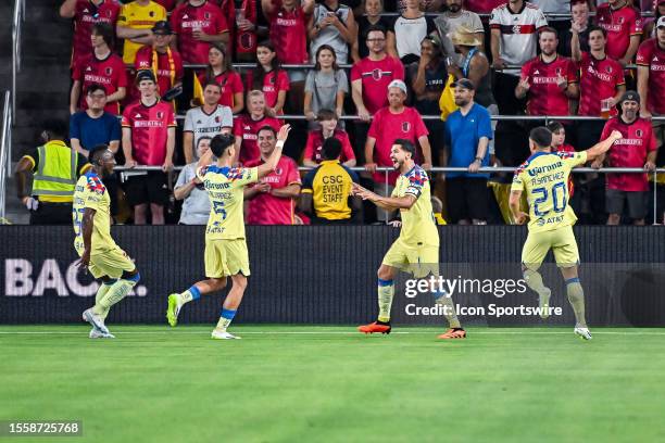 America forward Henry Martin is all smiles after scoring the first goal of the while his teammates come to celebrate with him during a League Cup...