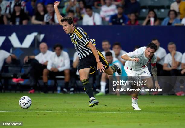 Federico Chiesa of Juventus runs past a tackle by Davide Calabria of Milan during the first half of the pre-season friendly match between Juventus...