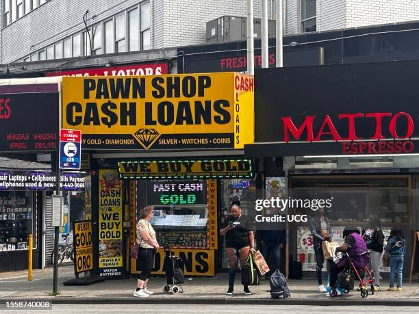 Busy bus stop in front of Pawn Shop, Queens, New York.