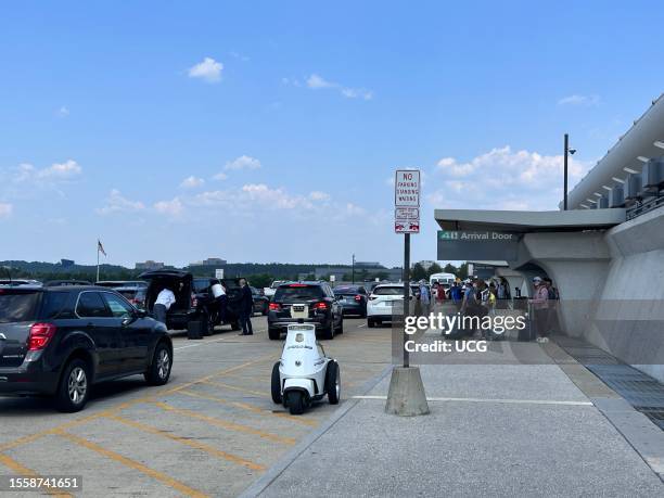 Passenger Arrival Door outside with Police traffic control scooter near no standing zone at Washington Dulles International Airport, Virginia.