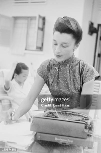 Chinese-born writer and physician Han Suyin at her typewriter, circa 1960.