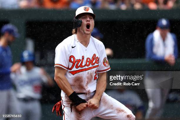 Gunnar Henderson of the Baltimore Orioles celebrates after scoring a run in the first inning against the Los Angeles Dodgers at Oriole Park at Camden...