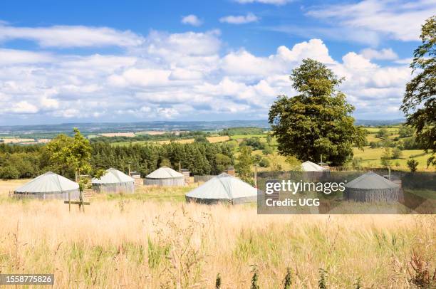 Yurts in the summer countryside at Swinton Bivouac glamping site on the Swinton Park Estate in the Yorkshire Dales in North Yorkshire.