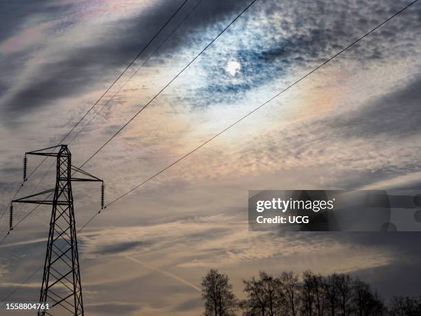 Electricity pylon in a field in Frilford, dramatic sun and cloudscape.