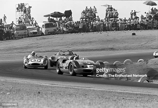 Times Grand Prix - Riverside. Bruce McLaren in his McLaren Elva Mk1 leads a group of cars coming out of a corner.