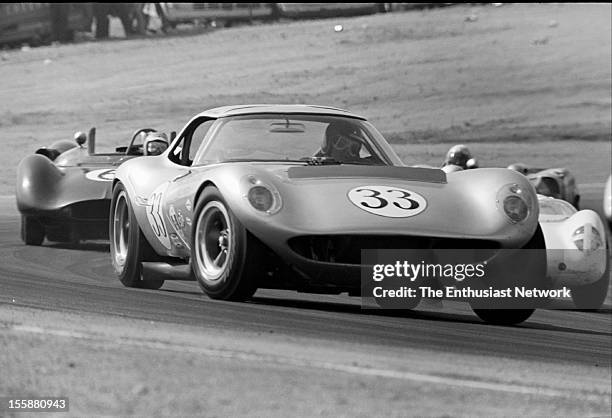 Times Grand Prix - Riverside. Mike Jones driver of the number 33 Cadillac powered Cheetah leads a group of cars coming out of a corner.