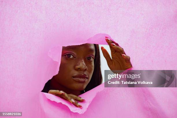 woman hidden charms at pink party - face in hole free stock pictures, royalty-free photos & images