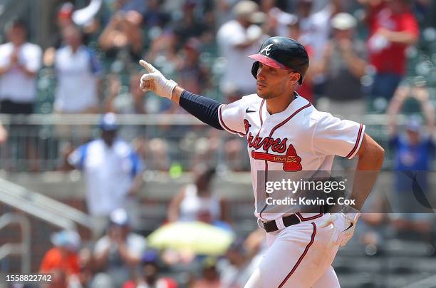 Matt Olson of the Atlanta Braves reacts as he rounds first base after hitting a two-run homer in the seventh inning against the Arizona Diamondbacks...