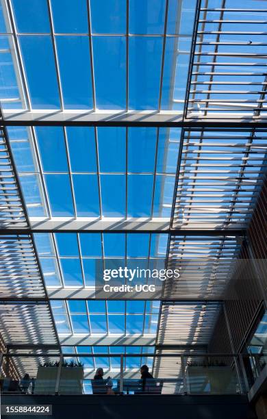 Main atrium of the Westgate Centre in Oxford, England, with two seated people.