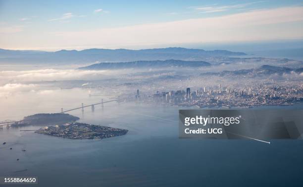 Aerial view of Oakland Bay Bridge and San Francisco, California. Pacific Ocean in background.