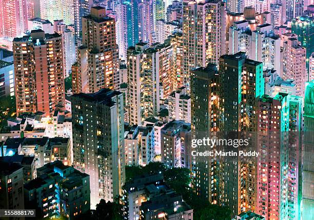 china, hong kong, apartment blocks at night - population explosion stock pictures, royalty-free photos & images