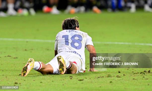 Milan's Argentine midfielder Luka Romero looks on after slipping and missing his team's first penalty during a penalty shootout at a pre-season...