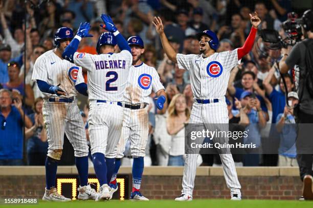 Nico Hoerner of the Chicago Cubs celebrates his grand slam with Mike Tauchman, Miles Mastrobuoni and Christopher Morel in the eighth inning against...