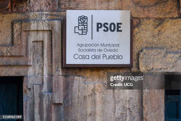 Oviedo, Asturias, Spain, A plaque on a textured wall displaying the inscription "PSOE, Agrupacion Municipal Socialista de Oviedo, Casa Del Pueblo"...
