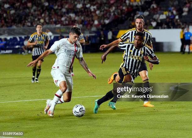 Christian Pulisic of AC Milan controls the ball against Alex Sandro of Juventus during the second half of the pre-season friendly match at Dignity...