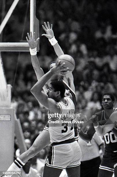 Earvin Magic Johnson of the Los Angeles Lakers looks to looks to pass the ball as Dennis Johnson of the Boston Celtics during an NBA Finals...