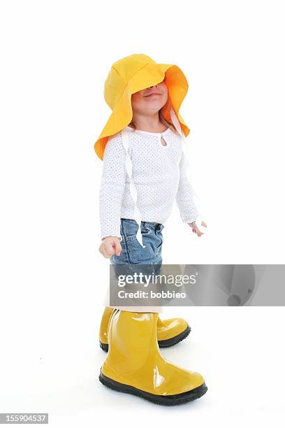 big shoe children: little girl in rain wear - kid in big shoes stock pictures, royalty-free photos & images