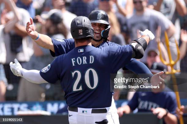Mike Ford celebrates his two run home run with Eugenio Suarez of the Seattle Mariners during the eighth inning against the Minnesota Twins at...
