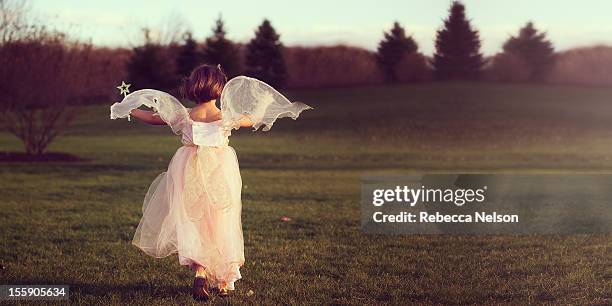 angelic fairy running at sunset - touched by an angel stockfoto's en -beelden