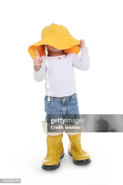 big shoe children: little girl in rain wear - kid in big shoes stock pictures, royalty-free photos & images