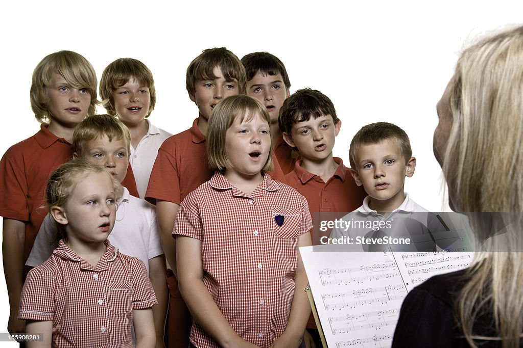 Primary school children in music lesson singing