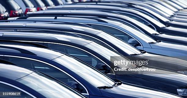 new cars in a row at dealership - car dealership stockfoto's en -beelden