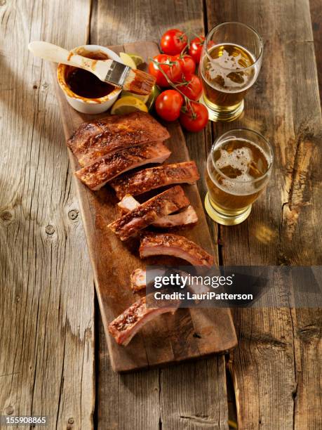 baby back pork ribs with a couple of beers - spareribs stock pictures, royalty-free photos & images