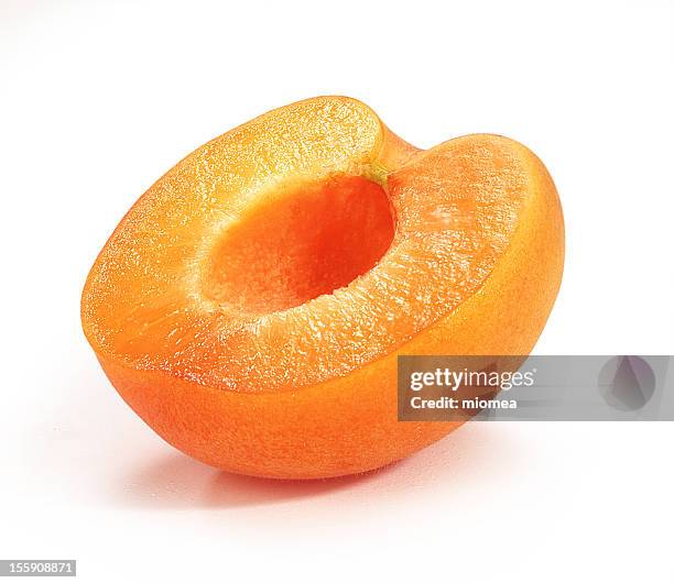 an ripe orange apricot cut in half - apricot stock pictures, royalty-free photos & images