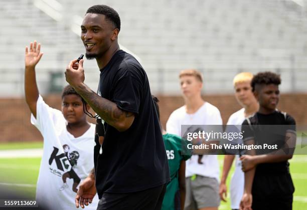 Washington Commanders strong safety Kamren Curl is shown holding football camp for kids in the his home town on July 1, 2023 at the Muskogee High...