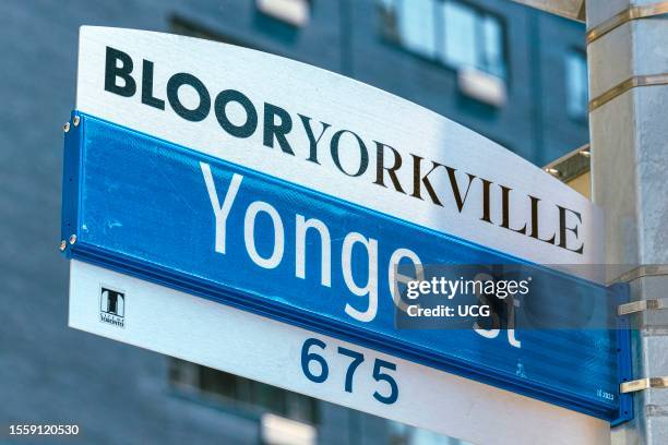 Toronto, Canada, Blooryorkville Yonge St 675 sign. A tall building is in the background.