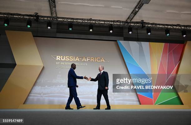 This pool image distributed by Sputnik agency shows Russian President Vladimir Putin greeting the leader of Mali's junta, Assimi Goita, during a...