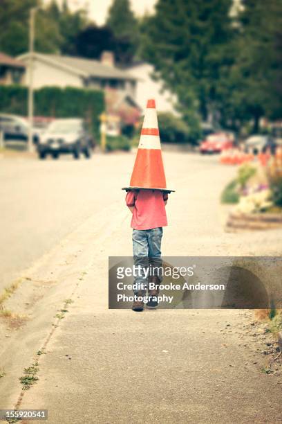 kid wearing safety cone - protection humour stock-fotos und bilder